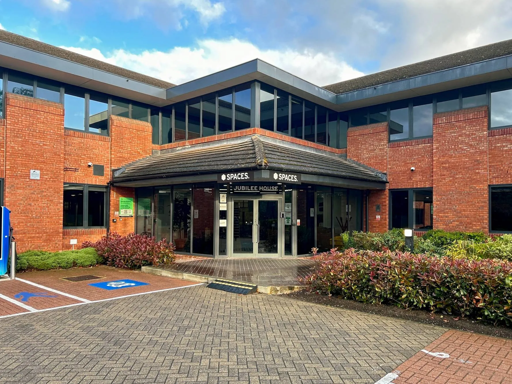 The front of Jubilee House at Globe Park, Marlow: the main entrance with visitor parking outside