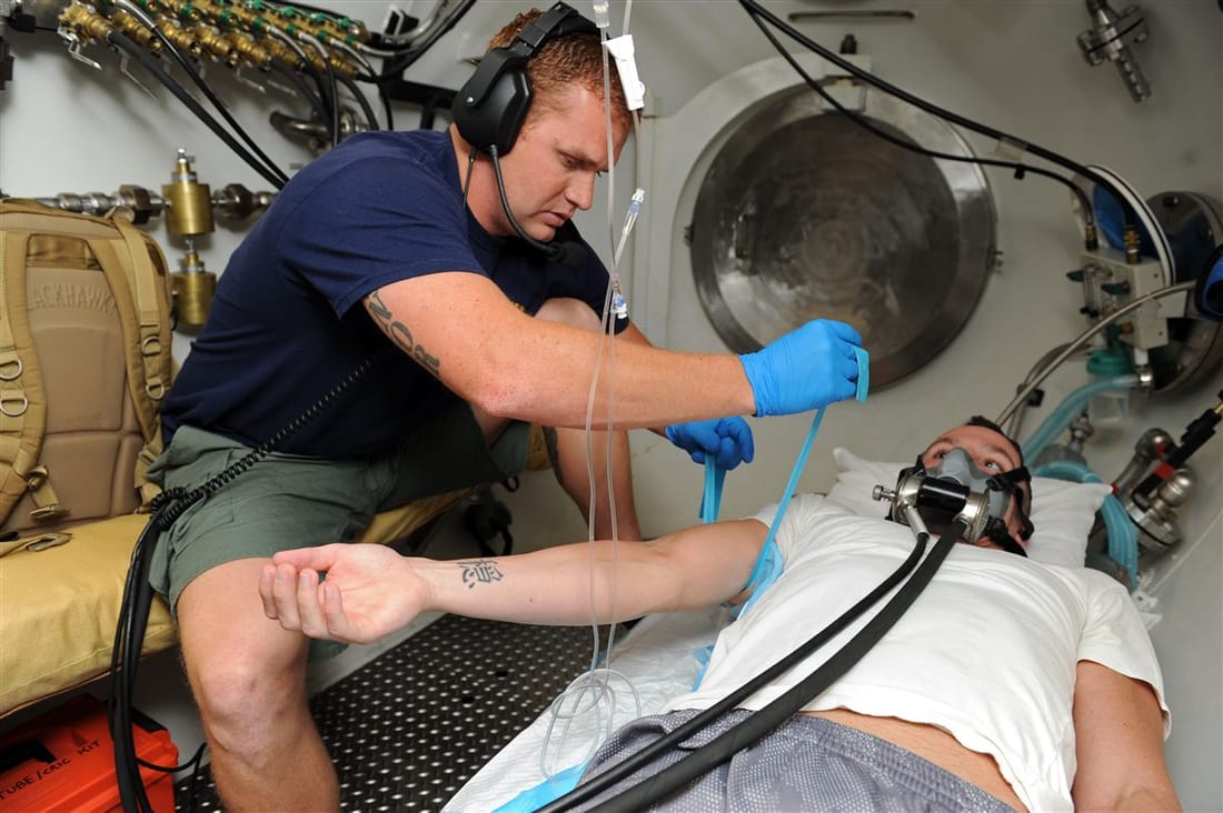 United States Navy sailors inside a decompression chamber - the modern recompression chamber owes its standardisation to the US Navy